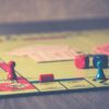 Custom board game printing solutions at ABPro Print, displaying tactical maps and accessory kits for multiplayer engagement