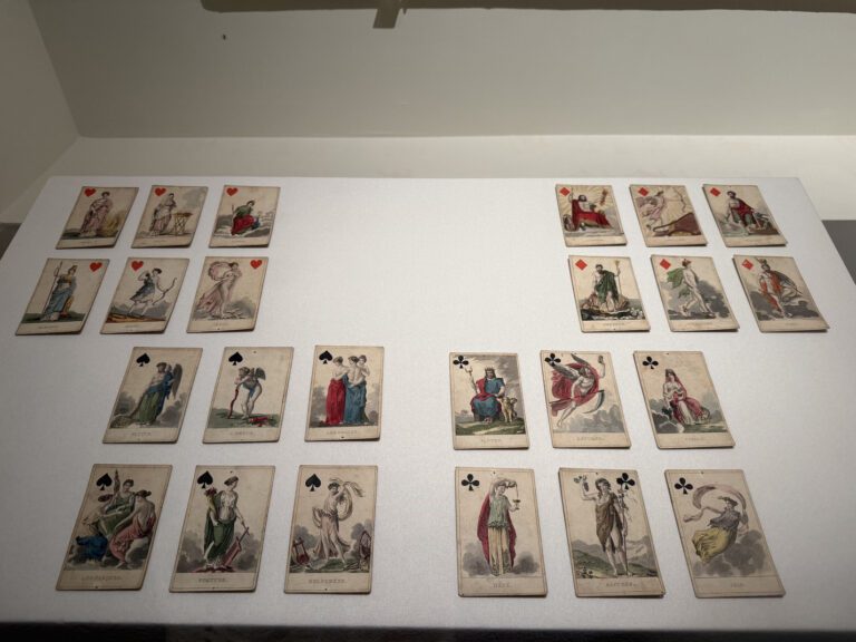Side-by-side view of antique Savoy playing cards and modern high-quality custom card game printing samples for tabletop professionals